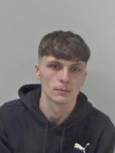 White male with short brown hair. 