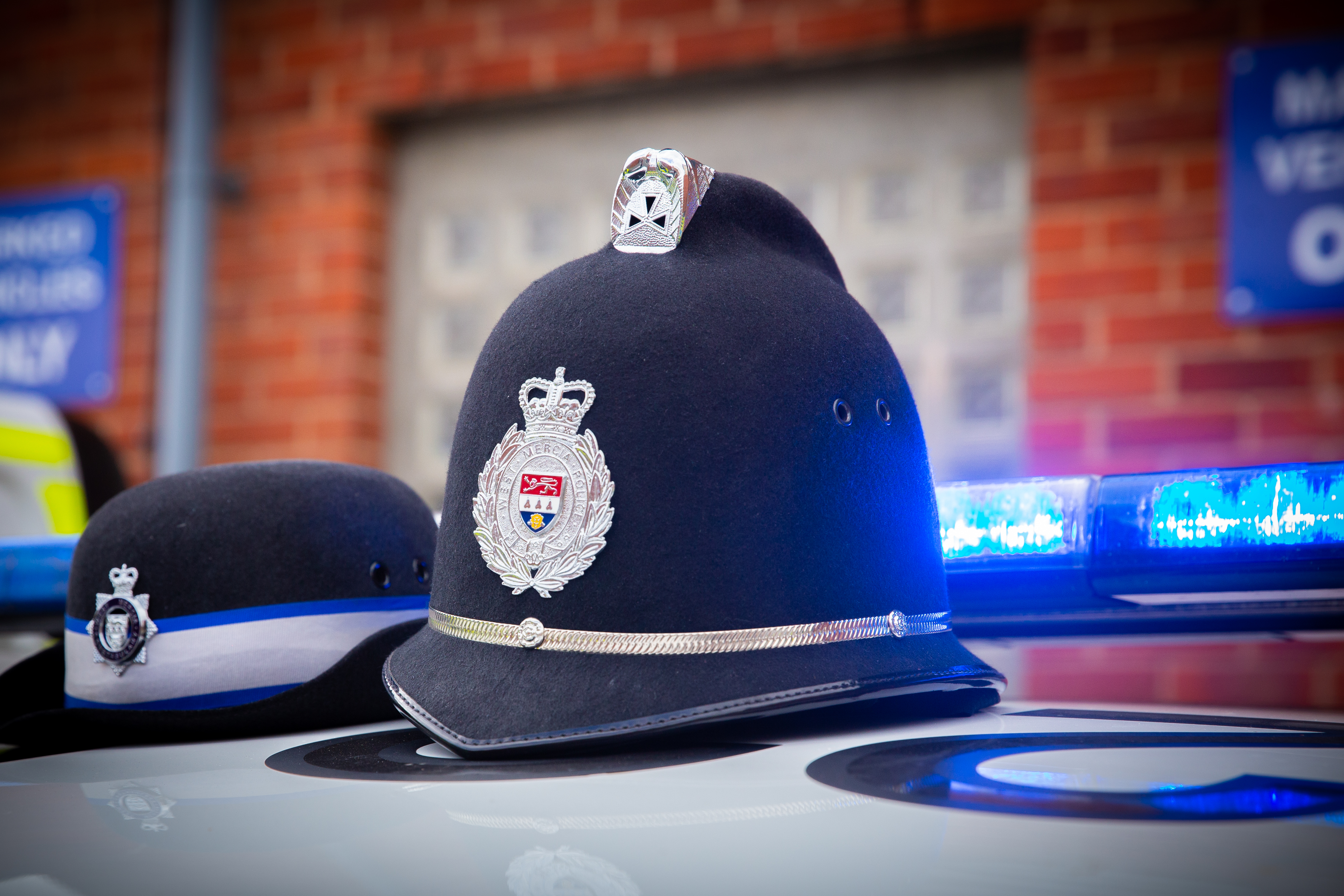 Police hats sat on top of a police car